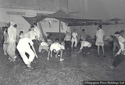 Protestors hurling stones at buses during Hock Lee Bus riots, 1955. 