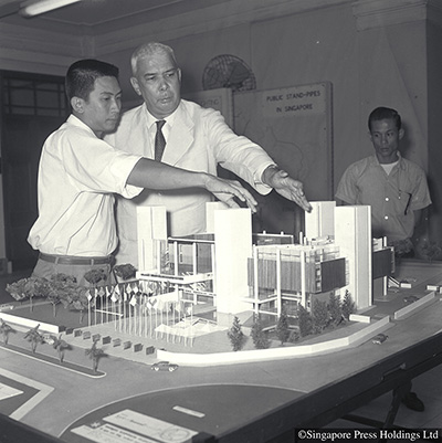 Architect Lim Chong Keat of Malayan Architects Co-Partnership, showing Law Minister KM Byrne the model of their prize-winning design of the Singapore Conference Hall and Trade Union House, 1962.