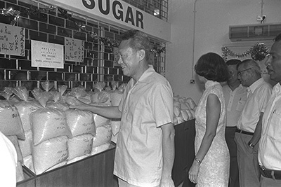 Prime Minister and Mrs Lee Kuan Yew checking out the prices of rice and sugar at the opening of the 7th NTUC Welcome Supermarket in Tanjong Pagar, 1976.