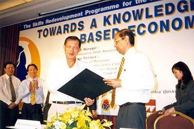 Mr Tan Soon Yam, General Secretary, Food, Drinks and Allied Workers Union, and Mr Pakir Singh, Chief Executive, Singapore Hotel Association after signing the Memorandum of Understanding to provide a framework to train a knowledge-based workforce, 1998.